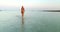 Woman entering into sea at Slatinica beach, Croatia