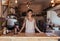 Woman entrepreneur standing at the billing counter of her cafe