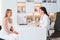 Woman esthetician consults a client in a cosmetology clinic