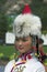 Woman in ethnic clothing and headpiece with fur and beads