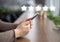 Woman evaluating mobile app on cellphone, cafe background