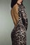 Woman in evening animal print dress back torso.