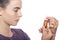 Woman is examine a bottle of homeopathic medicine