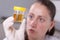 Woman examine urine container