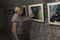 Woman examines a photo exhibition in one of dark halls Caves Bear Safari Park in Gelendzhik, Krasnodar region, Russia