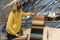 A woman examines samples of upholstery fabrics in a mall. A young blonde woman in a yellow sweater is buying a new sofa. Design