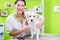 Woman is examining Dog for flea at pet groomer