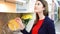 Woman examining kitchen sets in furniture store. Female opening cupboards in modern kitchen showroom