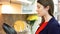 Woman examining kitchen sets in furniture store. Female opening cupboards in modern kitchen showroom