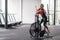 Woman exercise bike gym cycling training fitness. Fitness male using air bike cardio workout