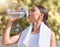 Woman, exercise and drink water, while running or training outside in summer for fitness. Lady, workout and bottle for