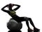 Woman exercising crunches fitness ball workout silhouette