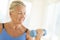 Woman Exercising With Dumbbell At Home