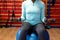 Woman exercising with dumbbell in sports center