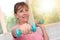 Woman exercising with dumbbells, light effect