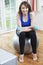 Woman Exercising In Front Of TV At Home