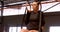 Woman exercising with gymnastic rings in fitness studio 4k