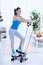 Woman exercising at home on stepper trainer