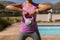 Woman exercising with kettlebell in the backyard of home