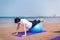 Woman exercising with pilates ball on the beach