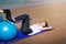Woman exercising with pilates ball on the beach
