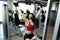 Woman exercising with a pulley machine at the gym