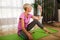 Woman exercising and stretching her body doing flexibility exercises, she drink water after exercise