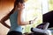 Woman Exercising On Treadmill Wearing Wireless Earphones And Smart Watch Checking Mobile Phone