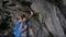 Woman exploring cave on Reynisfjara beach near Vik, Icealnd