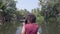 Woman exploring kerala backwaters by canoe