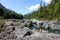 A woman exploring Wally Creek, on the way to Tofino.  The water is magical for swimming, the flowing creek water glistens