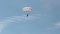 Woman is extremely down with a parachute to the ground. Parachute flight