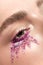 Woman eye with pink sequins