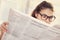 Woman eyeglasses newspaper reading