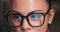 Woman, eyes and coding with glasses of programmer for research and development at office. Closeup or face of female