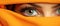 woman eyes mysterious gaze peering through a vibrant orange veil. Generative AI