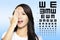 woman with eyesight test chart background