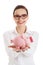 Woman in eyewear holding a piggybank