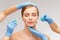 Woman face and beautician hands with syringe