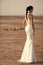 Woman face beauty. Woman posing in desert, back view