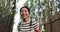 Woman, face and happy in bamboo forest for travel adventure, hiking and relax for journey, nature and park. Portrait