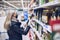 A woman in a face mask buys groceries in supermarket.