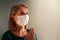 Woman in face mask praying for coronavirus victim