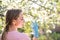 Woman with face mask on quarantine. Stay at home. Family concept. young woman blowing dandelion. glass of champagne on the beach.