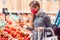 Woman with face mask shopping vegetables in supermarket