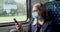 woman with face mask using mobile phone in train. safety in public transport