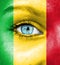 Woman face painted with flag of Mali