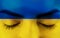 Woman face in ukraine flag colors. Ukraine flag painted over female face.
