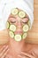 Woman with facial mask of cucumber