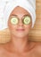 Woman with facial mask of cucumber